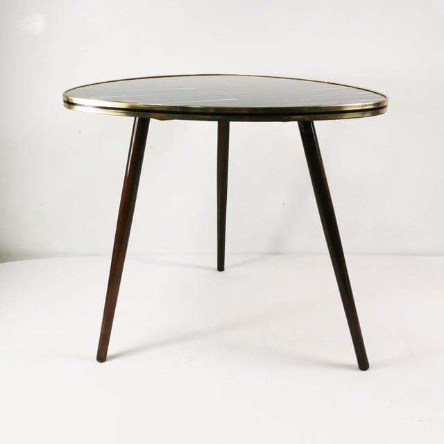 This coffee table comes from Germany in the 1960s. It is characterized by beautiful craftsmanship, a spacious form, and...