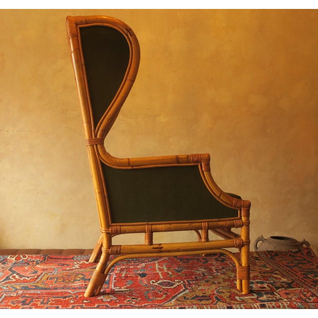 Mid century bambo wing lounge chair dating from 1960s. Nicely patinated bamboo, olive green fabric.