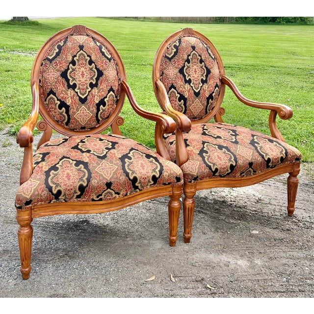 Stately pair of Louis XVI style oval back armchairs by Fairfield furniture. Mango wood frames with carved detail at top...