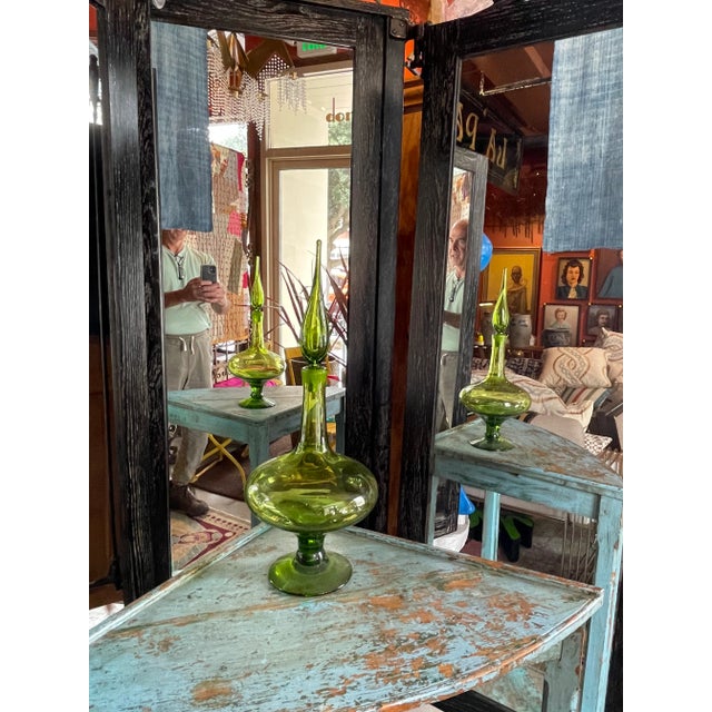 This is a beautiful mid century green Blenko glass bottle. Base is 5" diameter. A fantastic and colorful accessory that...