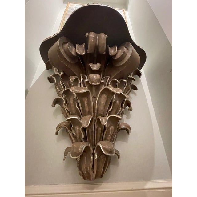 Gorgeous detail and hand silver gilt on this one of a kind hand carved hanging console. The top is a deep mahogany and the...