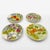 These four antique Saint-Clément majolica plates, dating from the 1950s/60s, celebrate garden fruits with the decorative...
