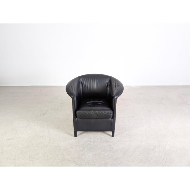 We are offering one of two beautiful Wittmann "Aura" armchairs in black leather for sale. Designed by Paolo Piva for...