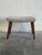 This charming accent ottoman features a neutral beige fabric cushion supported by slender tapered walnut legs. Its compact...