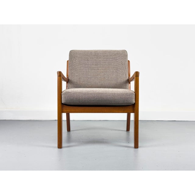 Elegant Senator armchair in high-quality teak, designed by Professor Ole Wanscher. This piece of furniture impresses with...