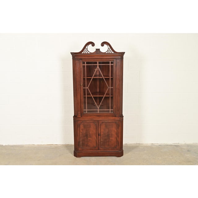 A gorgeous Georgian or Chippendale style corner bar cabinet, dining cabinet, or display cabinet In the manner of Baker...