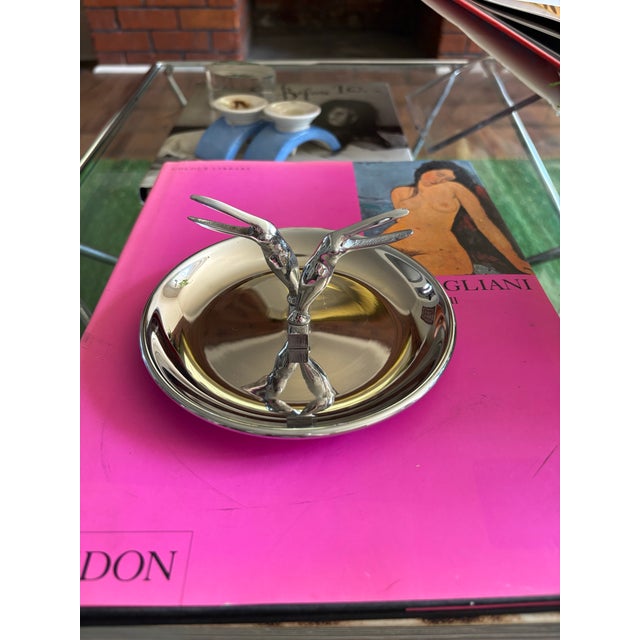 Sculptural silver ashtray from Restoration Hardware featuring an elegant dual crane design that functions as a built-in...