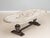Handcrafted in Italy, this oval dining table features an antique white finish with subtle grey undertones and hand-painted...