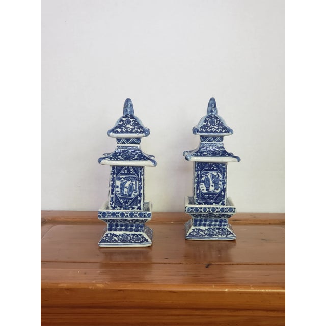 A pair of blue and white ceramic pagodas, cleverly fashioned as jars with removable lids. A lovely addition to a...