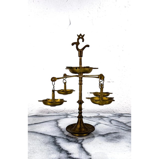 This is a hand made brass oil lamp also known as Panchmukhi Diya in India. It can be unscrewed into 3 pieces and is...