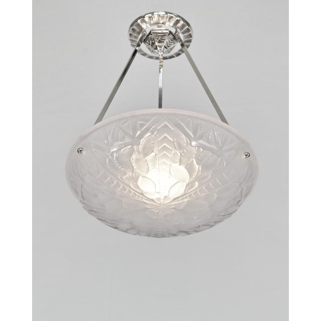 Georges Viarmé A French art deco pendant light circa 1930 in nickel plated bronze or solid brass. It holds a rare bowl...