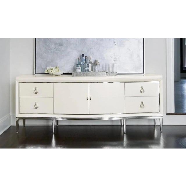Bernhardt Calista Entertainment Console. Features a soft, curved front with a silken pearl finish, polished stainless...