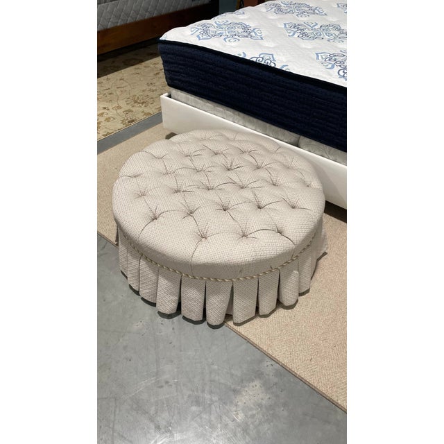 This well-crafted round ottoman by Ethan Allen features deep button tufting and a full tailored skirt for a polished,...