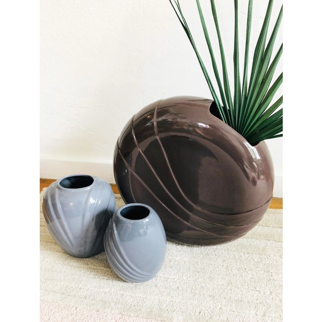 An extra large circular vintage 1980smodern ceramic vase. High gloss dark purple finish with an embossed design on each...