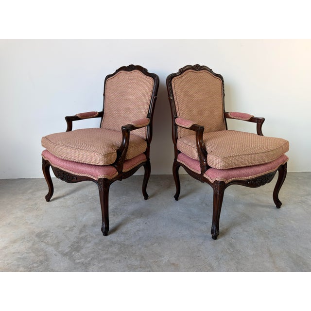 Bring timeless French elegance to your home with this beautiful pair of vintage Louis XV style armchairs. Featuring finely...