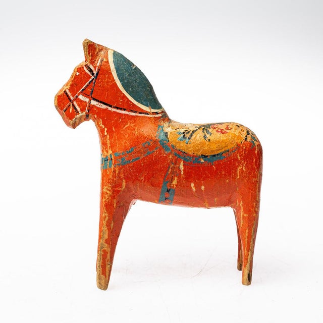A typical Swedish lucky horse, also called a Dala horse, in the special colors. The wear and tear on the old piece is...