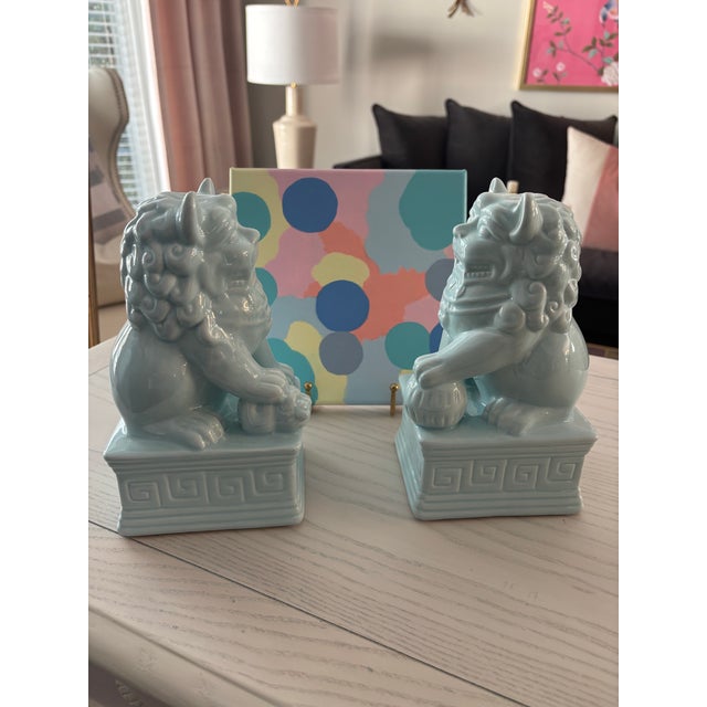 Pair of modern ceramic foo dogs in a lovely soft blue color. These are reproduction and new.