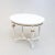 A stylish side or tea in oval form. White painted with bronzed shell decor. Baluster legs with rosettes and canned...