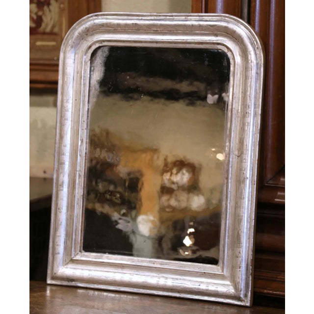 Crafted in the Burgundy region of France, circa 1870, the small antique mirror has traditional, timeless lines with...