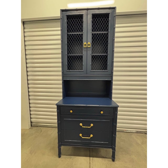 Offered is a two piece display/bookcase cabinet with base chest in faux bamboo details. Original hardware is on the base...
