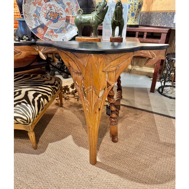 This is a wonderful pair of mid-century carved wood consoles in the style of Serge Roche. The tropical leaves that form...