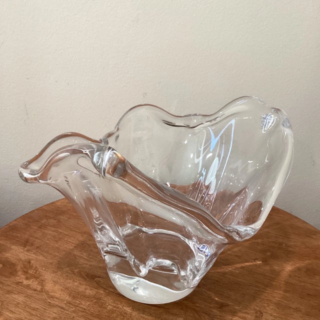 Clear glass vase with flowing waved opening