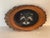 Vintage folk art painting on wood slab of an animal face for naturalistic decor.