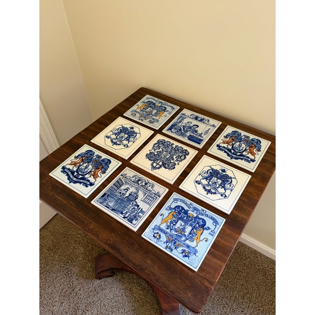 A classic set of nine Dutch Delft-style hand painted blue and white porcelain tiles featuring intricately rendered...