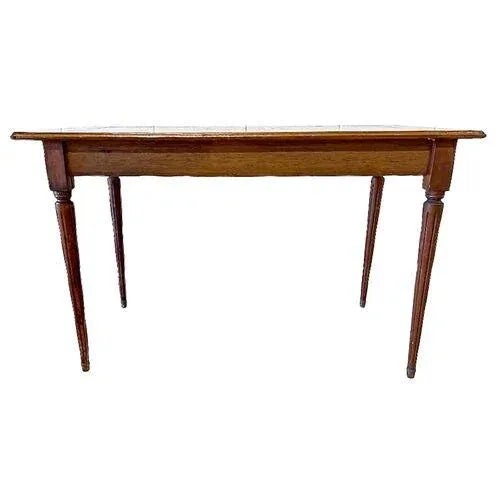 Vintage checkerboard wood inlaid game table with tapered fluted legs. Wood inlaid fleur de lis accents at each corner with...