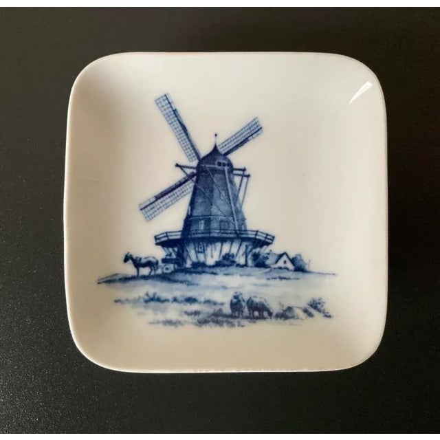 A beautiful square dish showing farm scene in rural Denmark Scandinavia, Europe, with windmill and farm animals in a...
