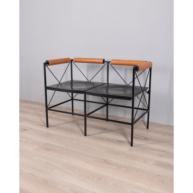 Two-seater bench in painted steel with leather armrests or backrest, "Lariana" model, designed by Marco Seveso and Gigi...
