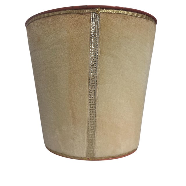 Charming little waste bin. It's metal, painted a very vintage orangey pink color and covered in a cream colored velvet. On...