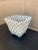 An elegant trompe l'oeil porcelain cachepot crafted in the form of a handwoven rope basket. Executed in glossy white...