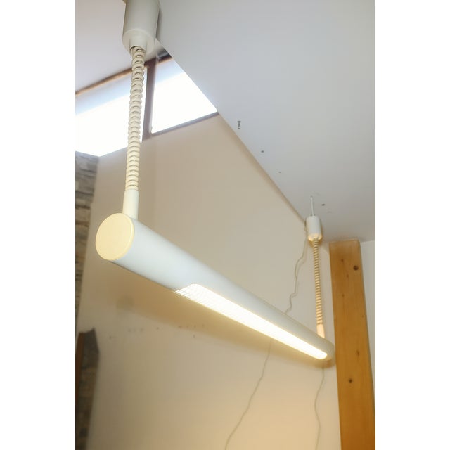 Pair of industrial pendant lamps by Massive. Belgium, 1980s. Tubular structure in lacquered acrylic. One is white, the...