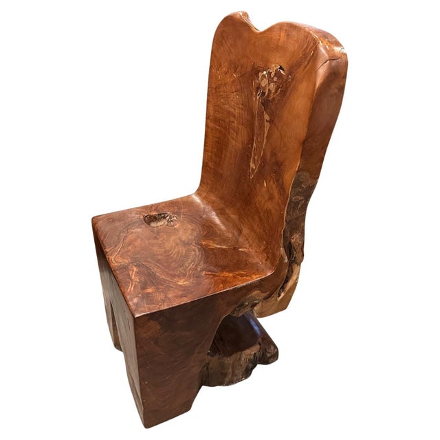 Beautiful aged teak wood hand carved chair. A single block of wood has been hand carved into this solid teak sculptural...