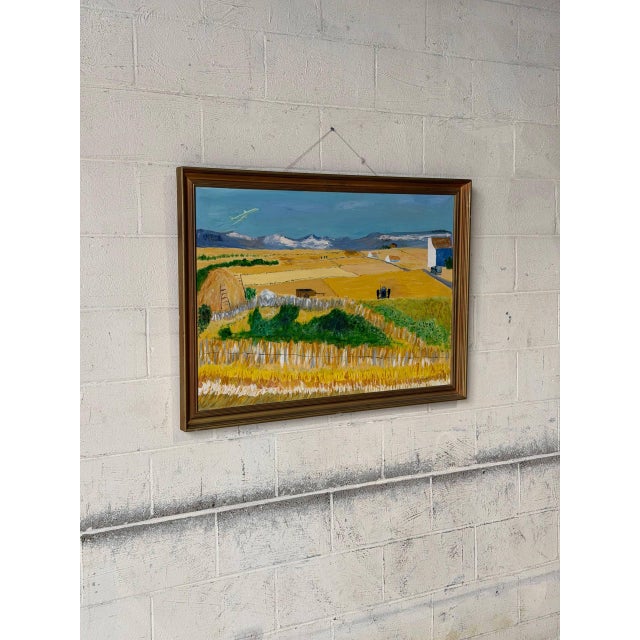 This landscape painting depicts a vibrant rural scene with golden fields, a distant mountain range, and a plane taking...