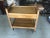Sleek Mid-Century Modern Danish bar cart constructed on handsomely grained teak with two tiers and two handy drawers under...