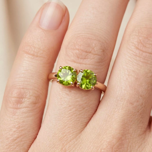 Embrace a fresh, vibrant elegance with this exquisite 18k gold-plated two-stone ring. Featuring a pair of brilliant-cut,...