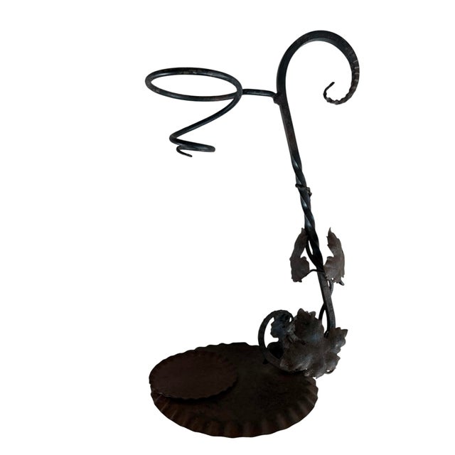 Great vintage wrought iron wine decanter stand featuring twisted vine and leaf details along the central stem.