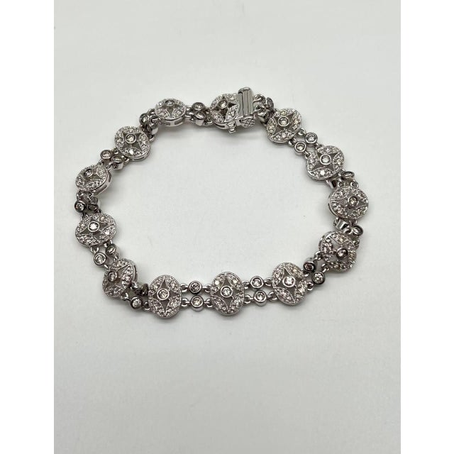 Elegant 14K White Gold bracelet with intricate circular links featuring sparkling embellishments.
