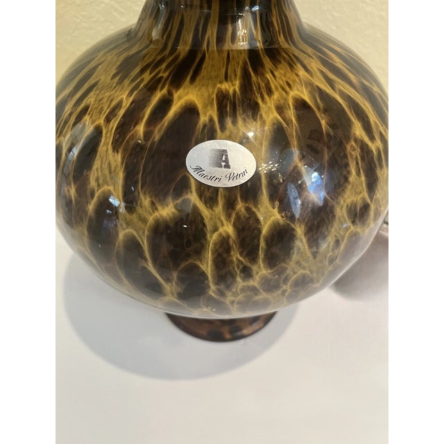 Capture the warm, swirling light of the Italian coast with this breathtaking vintage art glass vase from the legendary...