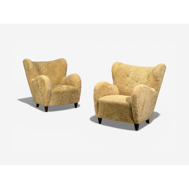 Sweden Mid-Century Modern, Organic Lounge Chairs, Honey Sheepskin, Wood, Sweden, 1940s Pair of beautiful organic form...