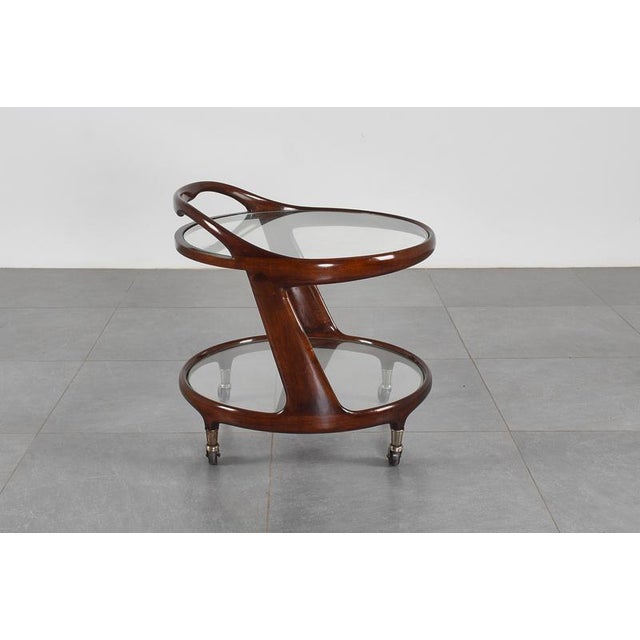 Very stylish bar cart with elegant curved wood profiles and a double circular tray. Attributed to Cesare Lacca, Italian...
