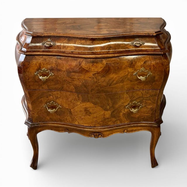 A classic Italian bombé form chest clad in patchwork olive burl. Three drawers adorned with aged brass pulls provide ample...