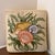 This is a decorative needlepoint throw pillow featuring a coastal or beach theme. The design includes three colorful...