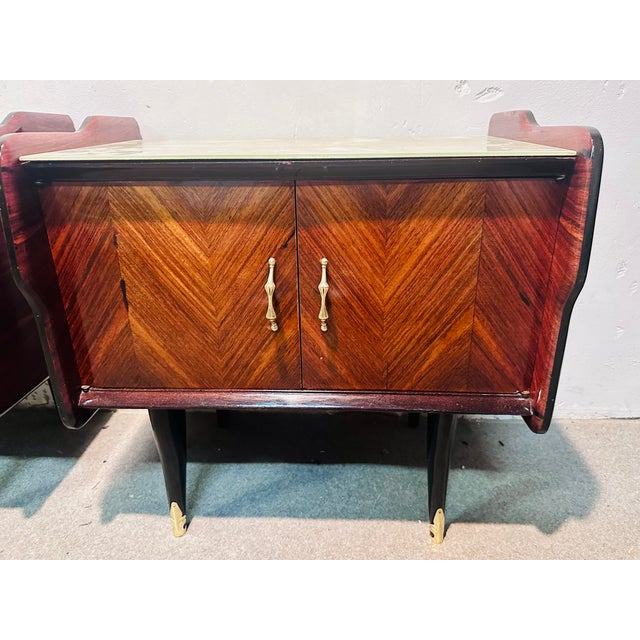 Pair of rosewood bedside tables with glass on the top, brass finishes.