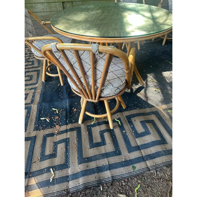 Immerse yourself in the charm of our Reed & Rattan Furniture Bamboo Round Table and Four Swivel Chairs with Pads. Designed...