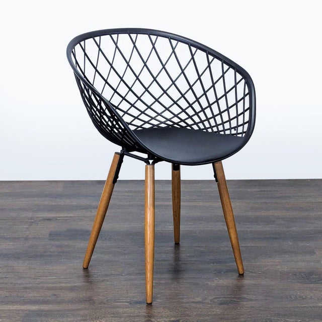 Made in Italy, the sleek molded plastic sculpts a woven crosshatch patterns on tapered solid ash wood legs. The...