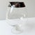 A classic mid-century cocktail pitcher with sleek silver rim. A perfect addition to your home bar.