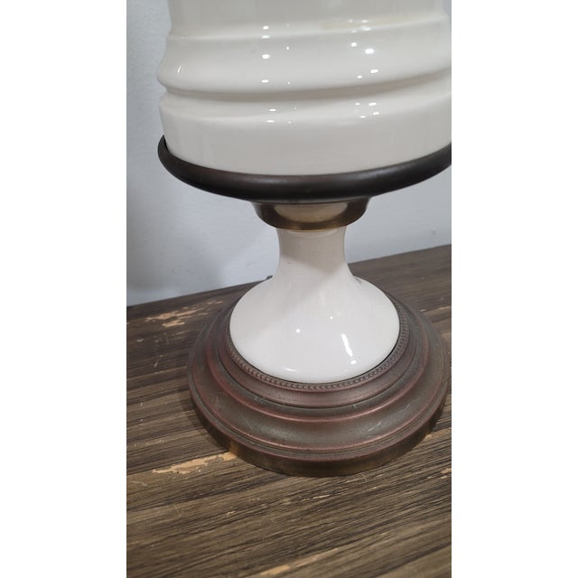 This beautiful table lamp set by Paul Hanson features a striking creamy white color with elegant brass accents. The lamp...